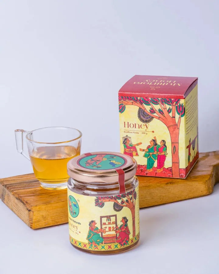Shabari Naturals Multiflora Honey jar and box with a glass of honey tea